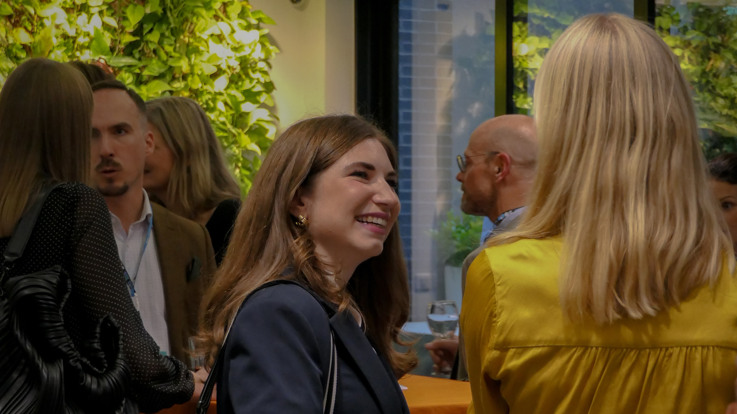 A group of people standing in a room.