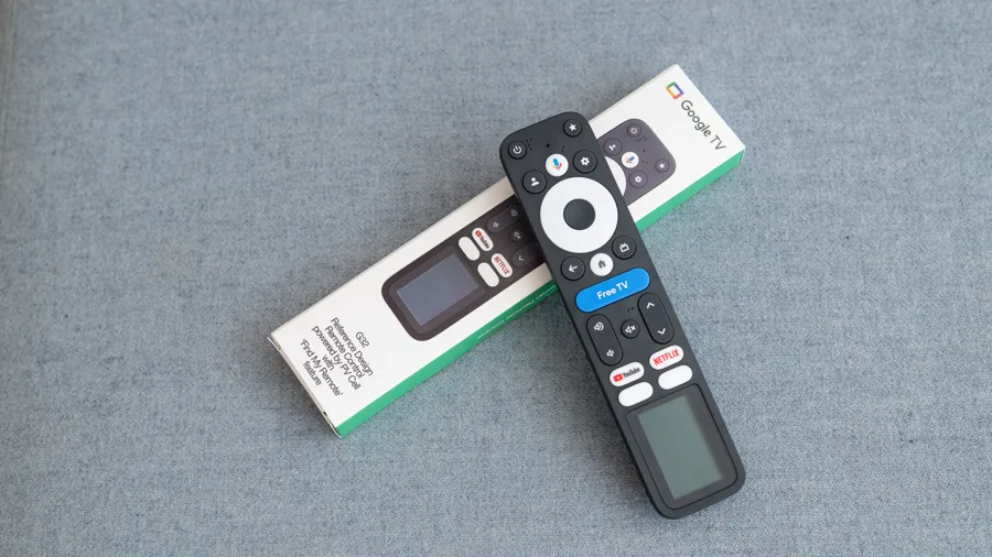 Two remote controls sitting on top of each other.