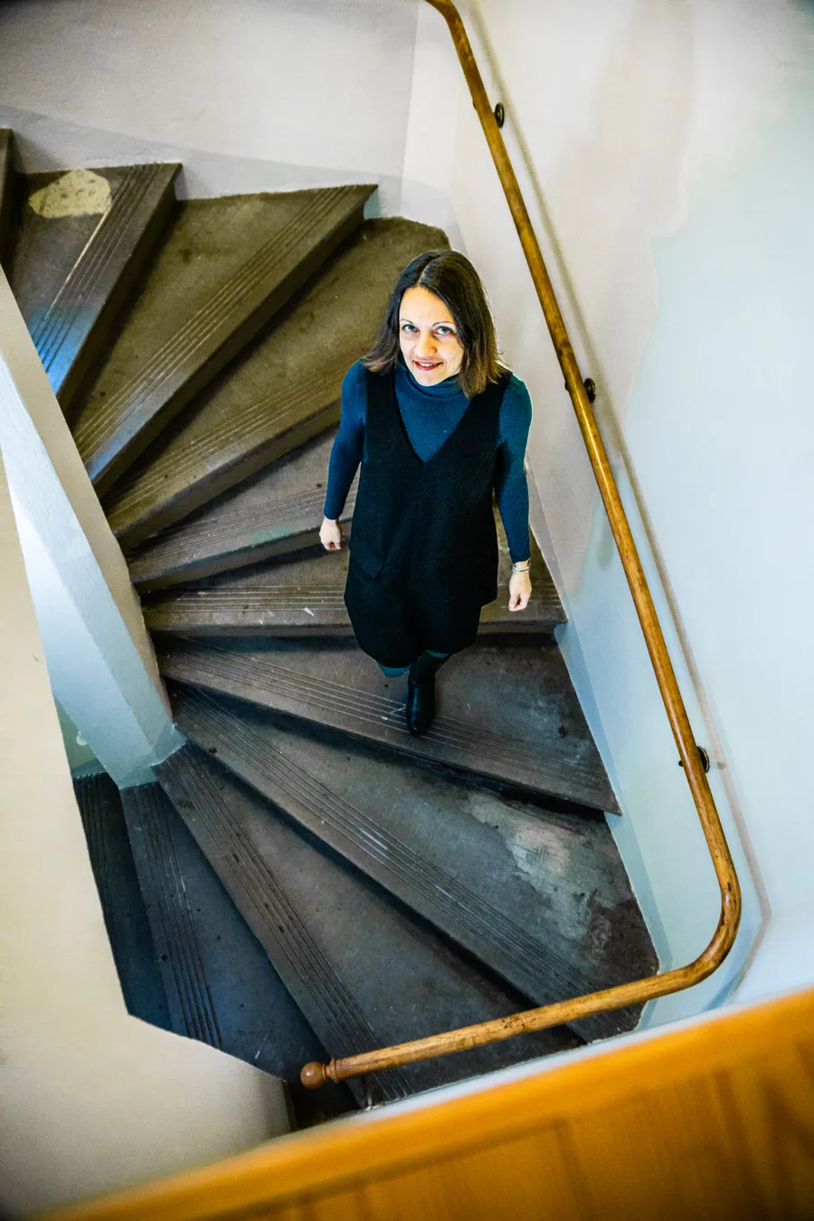 A woman walking down a flight of stairs.