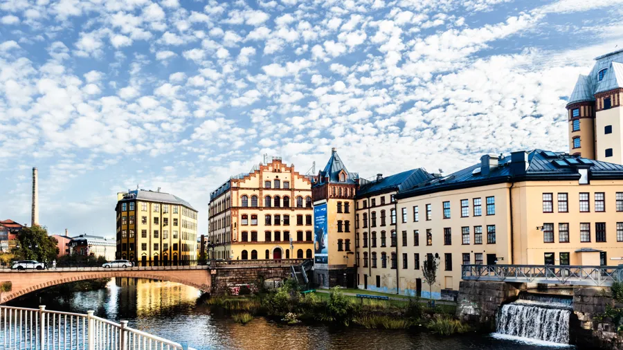 A river running through a city next to tall buildings.