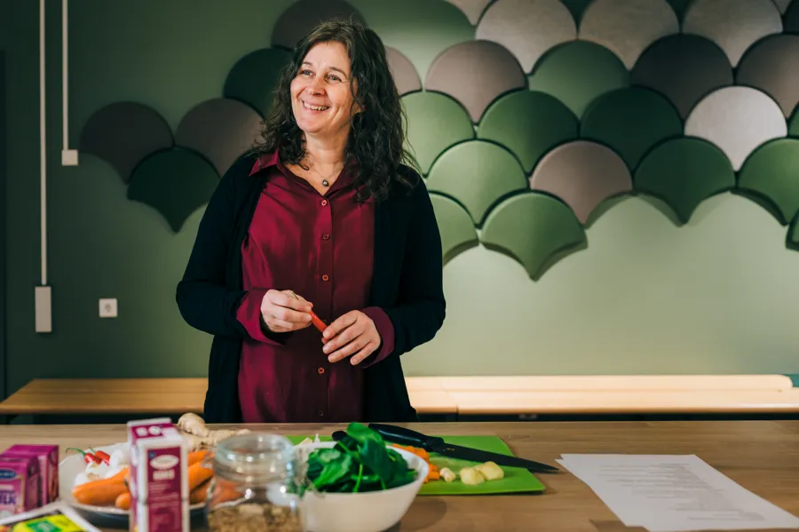 En kvinna står framför ett bord fullt av mat.