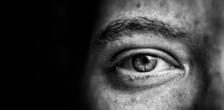 A black and white photo of a man's eye.