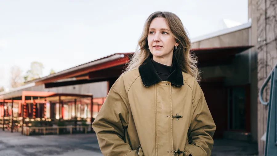 Woman walking on campus.