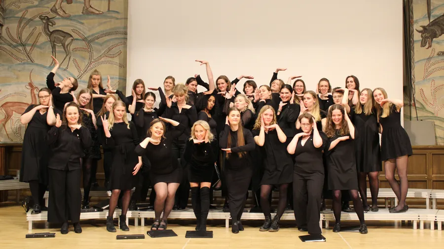 A group of women standing on top of a wooden floor.
