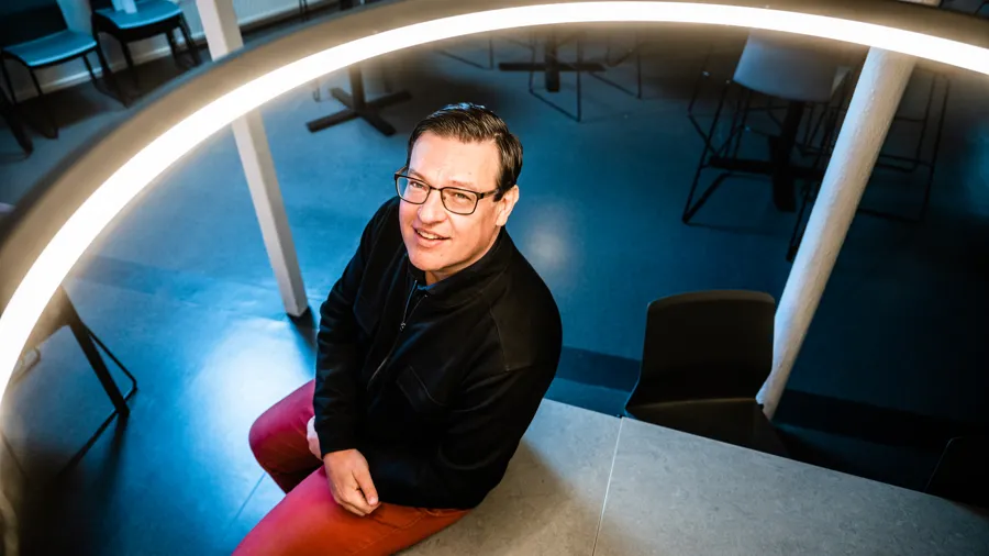 A man sitting on a chair in a room.